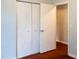 A closet door in a room with outlets on the wall and wooden floor at 679 Winchester Ln, Norcross, GA 30071