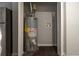 Water heater in closet with gray walls and dark hardwood floors at 679 Winchester Ln, Norcross, GA 30071
