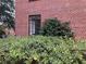 Exterior view of a red brick building, with greenery in front of a window at 1148 Briarcliff Ne Rd # 1, Atlanta, GA 30306