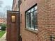 A ground view of the exterior of the red brick building, showing a large window at 1148 Briarcliff Ne Rd # 1, Atlanta, GA 30306