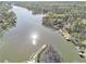 Panoramic aerial view showcases the serene lake and lush greenery surrounding the waterfront property at 2220 Emerald Dr, Jonesboro, GA 30236