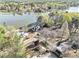 Aerial view of a waterfront home on a lake surrounded by lush greenery at 2220 Emerald Dr, Jonesboro, GA 30236