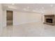 Large finished basement with elegant marble flooring and a brick fireplace at 2220 Emerald Dr, Jonesboro, GA 30236