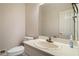Cozy half bathroom includes a toilet, a sink and a mirror at 2220 Emerald Dr, Jonesboro, GA 30236
