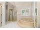 Luxurious bathroom featuring a glass-enclosed shower and a corner soaking tub at 2220 Emerald Dr, Jonesboro, GA 30236