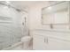 Modern bathroom featuring marble tile, glass enclosed shower, undermount sink, and custom cabinets at 2220 Emerald Dr, Jonesboro, GA 30236