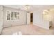 Bright bedroom with window, fan and an open entrance to the bathroom and closet at 2220 Emerald Dr, Jonesboro, GA 30236