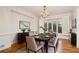 Elegant dining room with hardwood floors, chandelier, and large windows, furnished with a wooden table at 2220 Emerald Dr, Jonesboro, GA 30236