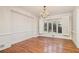 Well-lit dining room featuring hardwood floors, white trim, chandelier, and large windows with shutter at 2220 Emerald Dr, Jonesboro, GA 30236