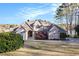 Inviting home features a manicured lawn, mature trees, and beautiful landscaping, providing excellent curb appeal at 2220 Emerald Dr, Jonesboro, GA 30236