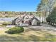 Stunning lakefront property boasts a well-maintained lawn, mature trees, and a private boat launch at 2220 Emerald Dr, Jonesboro, GA 30236