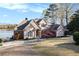View of exterior showcases pristine lawn, brick and stucco, and mature landscaping at 2220 Emerald Dr, Jonesboro, GA 30236