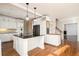Bright kitchen with white cabinetry, an island with cooktop, and stainless steel appliances at 2220 Emerald Dr, Jonesboro, GA 30236