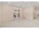 Bright living room featuring elegant marble floors, recessed lighting, and glass doors to the outdoors at 2220 Emerald Dr, Jonesboro, GA 30236