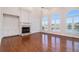 Bright living room with hardwood floors, fireplace, and large windows offering serene water views at 2220 Emerald Dr, Jonesboro, GA 30236