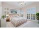 Stylish main bedroom features ample sunlight and a large bed with views of the surrounding landscape at 2220 Emerald Dr, Jonesboro, GA 30236