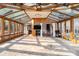 Large sunroom with wood-trimmed glass walls, a fan, and views of the surrounding property at 2220 Emerald Dr, Jonesboro, GA 30236