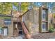 A charming condo featuring a wooden exterior and staircase in a wooded setting at 3111 Fairington Dr, Lithonia, GA 30038