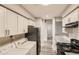 Well-lit kitchen featuring granite counters, white cabinets, and black appliances at 3111 Fairington Dr, Lithonia, GA 30038