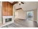 Spacious living room featuring wood-look flooring, ceiling fan, and fireplace at 3111 Fairington Dr, Lithonia, GA 30038