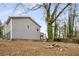 Backyard with gray-sided home, a fire pit, and privacy fence at 360 Peyton Sw Rd, Atlanta, GA 30311
