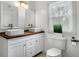 Stylish bathroom with dual vessel sinks, a wood countertop, and a modern faucet at 360 Peyton Sw Rd, Atlanta, GA 30311