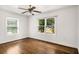 Bedroom with hardwood flooring, a ceiling fan, and two bright windows at 360 Peyton Sw Rd, Atlanta, GA 30311