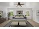 Bright bedroom featuring a ceiling fan, neutral decor, and natural light from two windows at 360 Peyton Sw Rd, Atlanta, GA 30311