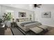 Cozy bedroom with two white cushioned benches, neutral walls, and a ceiling fan at 360 Peyton Sw Rd, Atlanta, GA 30311