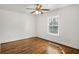 Bedroom featuring hardwood floors, ceiling fan, and a window overlooking the exterior at 360 Peyton Sw Rd, Atlanta, GA 30311