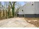 View of home's exterior with gray siding, leading to a small deck and spacious concrete driveway at 360 Peyton Sw Rd, Atlanta, GA 30311