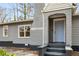 Close-up view of the home's entrance showcasing a light blue front door and grey painted brick entryway at 360 Peyton Sw Rd, Atlanta, GA 30311