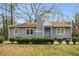 Charming single-story home with gray siding, blue door, brick chimney, and well-maintained landscaping at 360 Peyton Sw Rd, Atlanta, GA 30311
