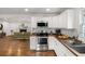 Modern kitchen with stainless steel appliances, butcher block counters, and white cabinetry open to living room at 360 Peyton Sw Rd, Atlanta, GA 30311