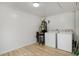 Functional laundry area with washing machine, dryer, and neutral walls with wood-look flooring at 360 Peyton Sw Rd, Atlanta, GA 30311
