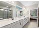 Elegant bathroom featuring a double sink vanity, glass shower, and access to the main bedroom at 130 Brayden Park Dr, Canton, GA 30115