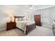 Comfortable bedroom with ceiling fan, windows, and stylish dark wood furniture at 130 Brayden Park Dr, Canton, GA 30115