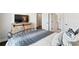 Bedroom view showcases stylish bed and accent pillows and a view of the ensuite bathroom at 130 Brayden Park Dr, Canton, GA 30115