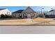 Clubhouse exterior with brick facade, and sidewalk leading to double-door entrance at 130 Brayden Park Dr, Canton, GA 30115