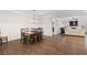 Open-concept dining area with hardwood floors, wainscoting, and seamless flow to living room at 130 Brayden Park Dr, Canton, GA 30115