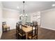 Spacious dining area with hardwood floors and an open view into the kitchen at 130 Brayden Park Dr, Canton, GA 30115
