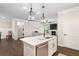 Modern kitchen island view looking into the living room area with a fireplace at 130 Brayden Park Dr, Canton, GA 30115