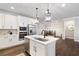 This is a modern kitchen featuring an island, stainless steel appliances and an eat-in dining area at 130 Brayden Park Dr, Canton, GA 30115