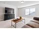 Bright living room with ample space, tv, and comfortable seating arrangement at 130 Brayden Park Dr, Canton, GA 30115