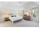 Spacious main bedroom with tray ceiling and large windows offers a serene retreat at 130 Brayden Park Dr, Canton, GA 30115