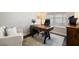 Comfortable home office featuring a wooden desk, modern chair, and natural light from the window at 130 Brayden Park Dr, Canton, GA 30115