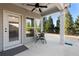 Covered patio boasts ceiling fan, neutral concrete flooring, and backyard views at 130 Brayden Park Dr, Canton, GA 30115