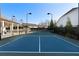 Well-maintained tennis court with black net and tall lighting poles at 130 Brayden Park Dr, Canton, GA 30115