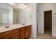 Bathroom with double vanity, wood cabinets, and a view of the shower at 160 Glenmore Ln, Mcdonough, GA 30253