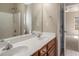 Bathroom with double vanity, wood cabinets, and shower at 160 Glenmore Ln, Mcdonough, GA 30253